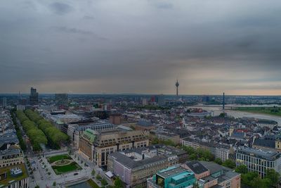 High angle view of buildings against cloudy sky