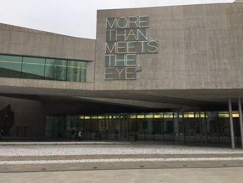 Text on wall against sky