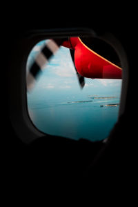 Close-up of red glass window against black background