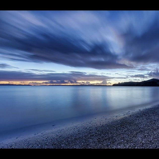 water, sky, scenics, cloud - sky, tranquil scene, beauty in nature, tranquility, cloudy, sea, beach, nature, shore, weather, idyllic, cloud, dusk, overcast, sunset, auto post production filter, dramatic sky