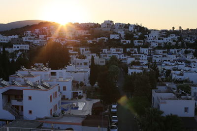 Aerial view of townscape against sky at sunset