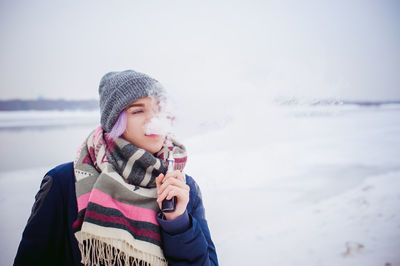 Full length of happy girl standing on snow covered landscape