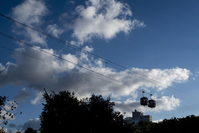 Low angle view of silhouette trees against sky