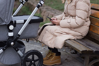 Low section of woman sitting on bench