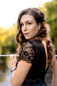 Portrait of beautiful young woman standing outdoors