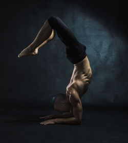 Studio shot of man doing yoga