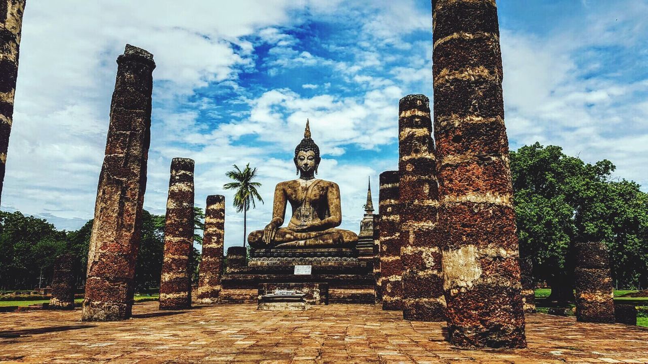 STATUE OF TEMPLE AGAINST CLOUDY SKY