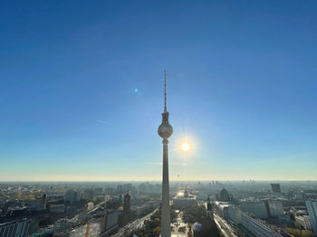 Tower amidst buildings in city against sky