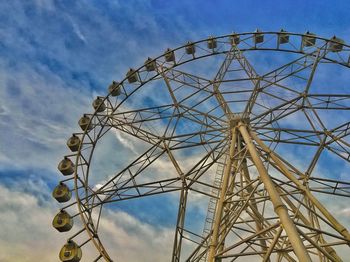 Low angle view of ferris wheel against blue sky