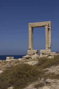 Built structure on beach against clear blue sky