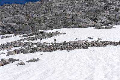 Scenic view of snow on rock against sky