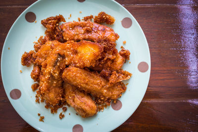 Directly above shot of deep fried bananas in plate on wooden table