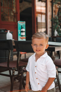 Portrait of boy standing on table