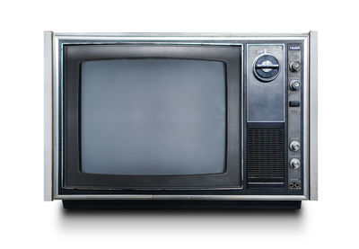 Close-up of vintage television on white background
