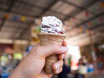 Close-up of hand holding ice cream cone