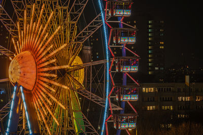 Illuminated ferris wheel at night