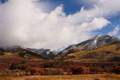 Scenic view of mountains against cloudy sky