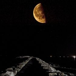 Low angle view of moon against sky at night