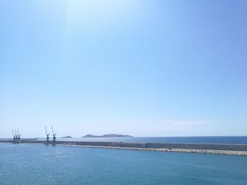 Scenic view of sea against clear blue sky