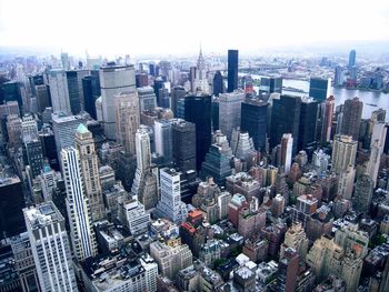 High angle view of modern buildings in city against sky