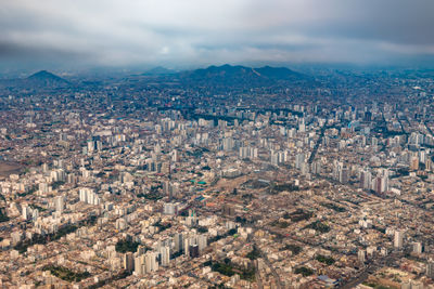 Aerial perspective highlights the vast urban sprawl of lima.
