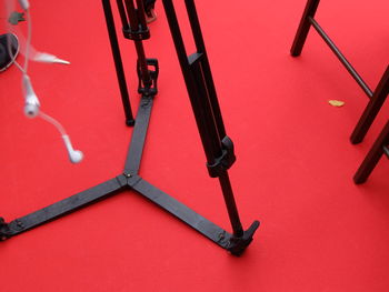 Low section of tripod on red carpet 