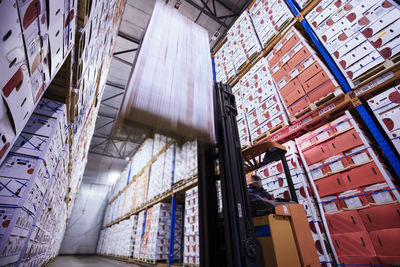 Moving forklift in factory hall loading boxes