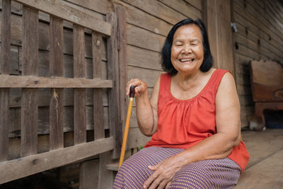 Smiling senior woman sitting outdoors