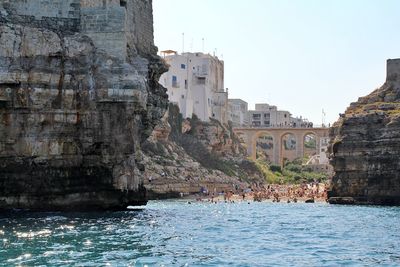 Bridge over the beach, bay in polignano a mare, simple white buildings in the south of italy