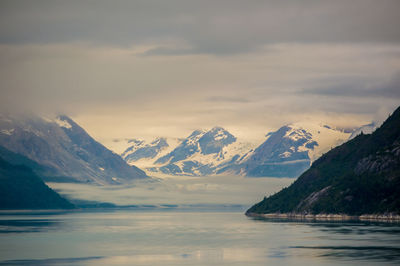 Scenic view of lake and mountains against sky