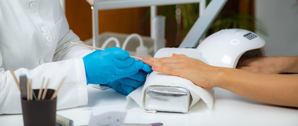 Close-up of woman hand holding finger