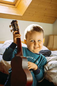 Portrait of boy playing guitar