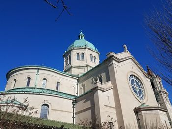 Low angle view of bell tower against blue sky