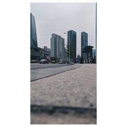 City street by buildings against sky