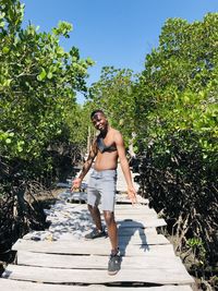 Full length of woman on tree against sky