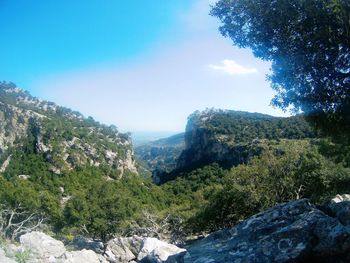 Scenic view of mountains against blue sky