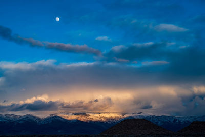 Scenic view of snowcapped mountains against sky during sunset