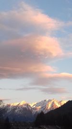 Scenic view of snowcapped mountains against sky during sunset