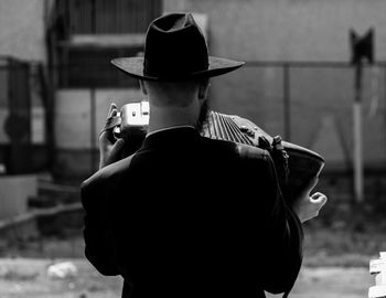 Young woman standing against wall