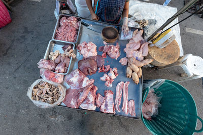 High angle view of people selling meat at a market stall in thailand