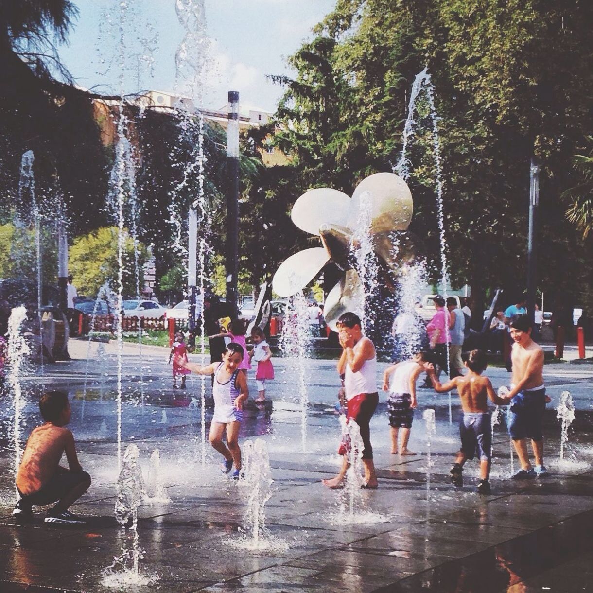 leisure activity, lifestyles, water, tree, enjoyment, fun, men, full length, person, childhood, playing, boys, motion, large group of people, togetherness, girls, day, jumping, waterfront