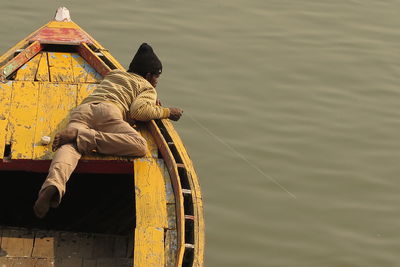 Man sitting on boat in water