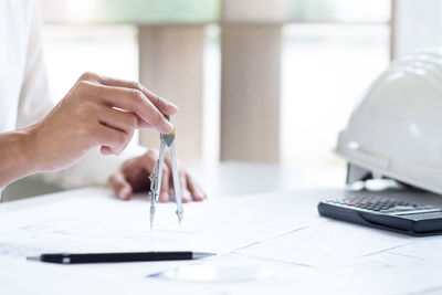 Midsection of woman working on table
