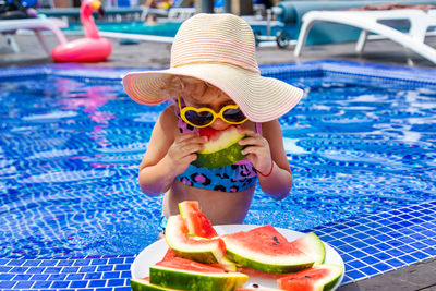 High angle view of woman wearing hat while swimming in pool