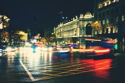 Cars on city street during rainy season at night