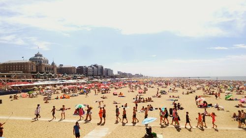 People at beach against sky