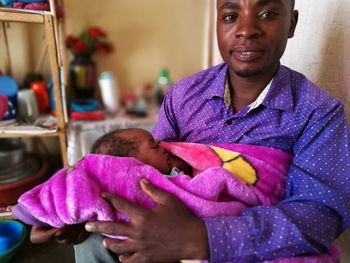 Portrait of happy mother holding baby