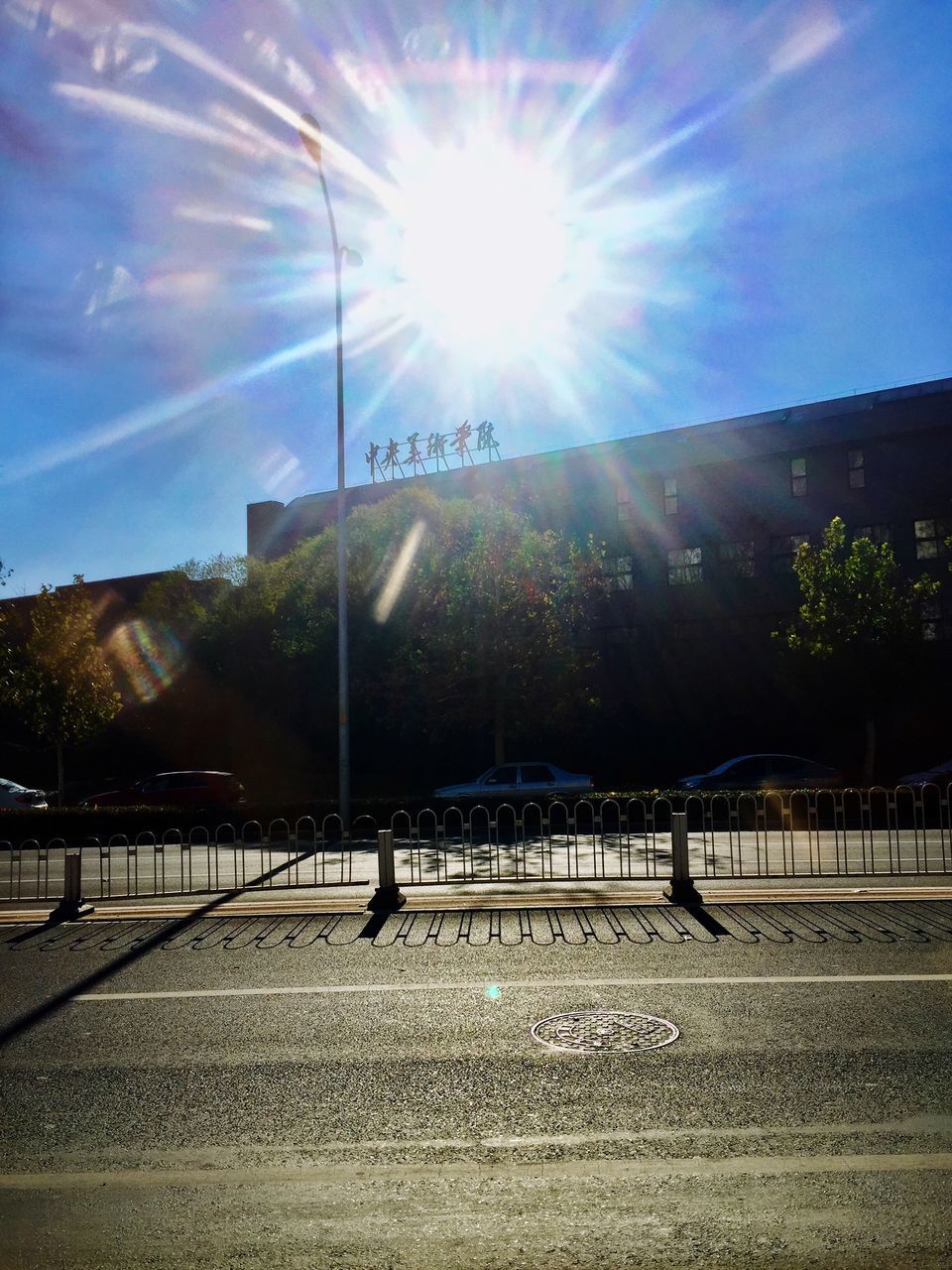 sunlight, sunbeam, lens flare, sky, sun, outdoors, railing, tree, built structure, day, architecture, no people, building exterior, nature