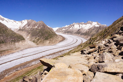 Scenic view of mountains against clear blue sky