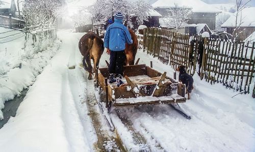 Woman covering face covered with snow